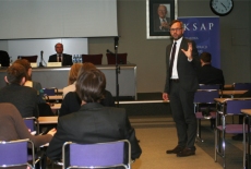 Niemiecki Sekretarz Stanu Michael Roth mówi do zebranych na sali uczestników spotkania. W głębi pomieszczenia za podium siedzi wicedyrektor szkoły Pan Marek Haliniak