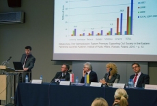 fot. Sebastian Szulfer/KSAP Pan stoi przy mównicy i przemawia obok przy stole prezydialnym siedzą pozostali prowadzący